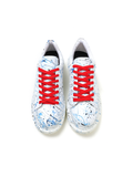 Pair of sneakers with red laces on a white background