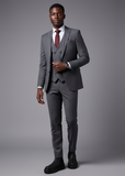 Man in a tailored grey suit wearing black Apollo Moda Avalon Chelsea boots for a refined look.