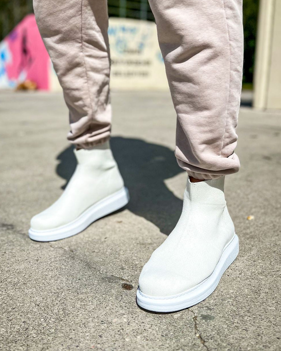 Apollo Moda Torino X White boots worn with light pink pants on a concrete surface.